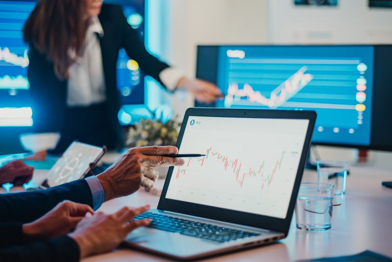 Crop businesspeople analyzing graph during meeting